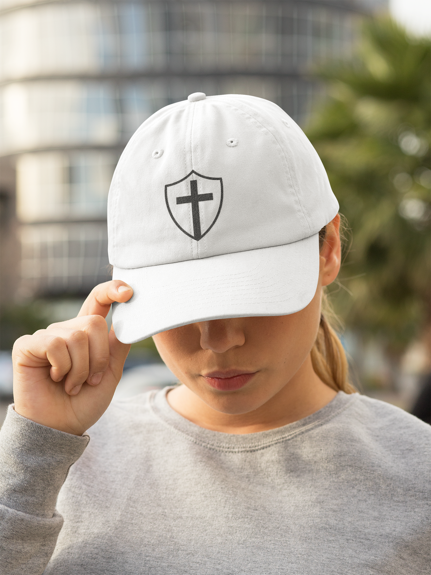 women wearing Shield of God Christian Dad Cap with embroidered faith design – spiritual armor baseball hat for men and women – Christian streetwear accessory"